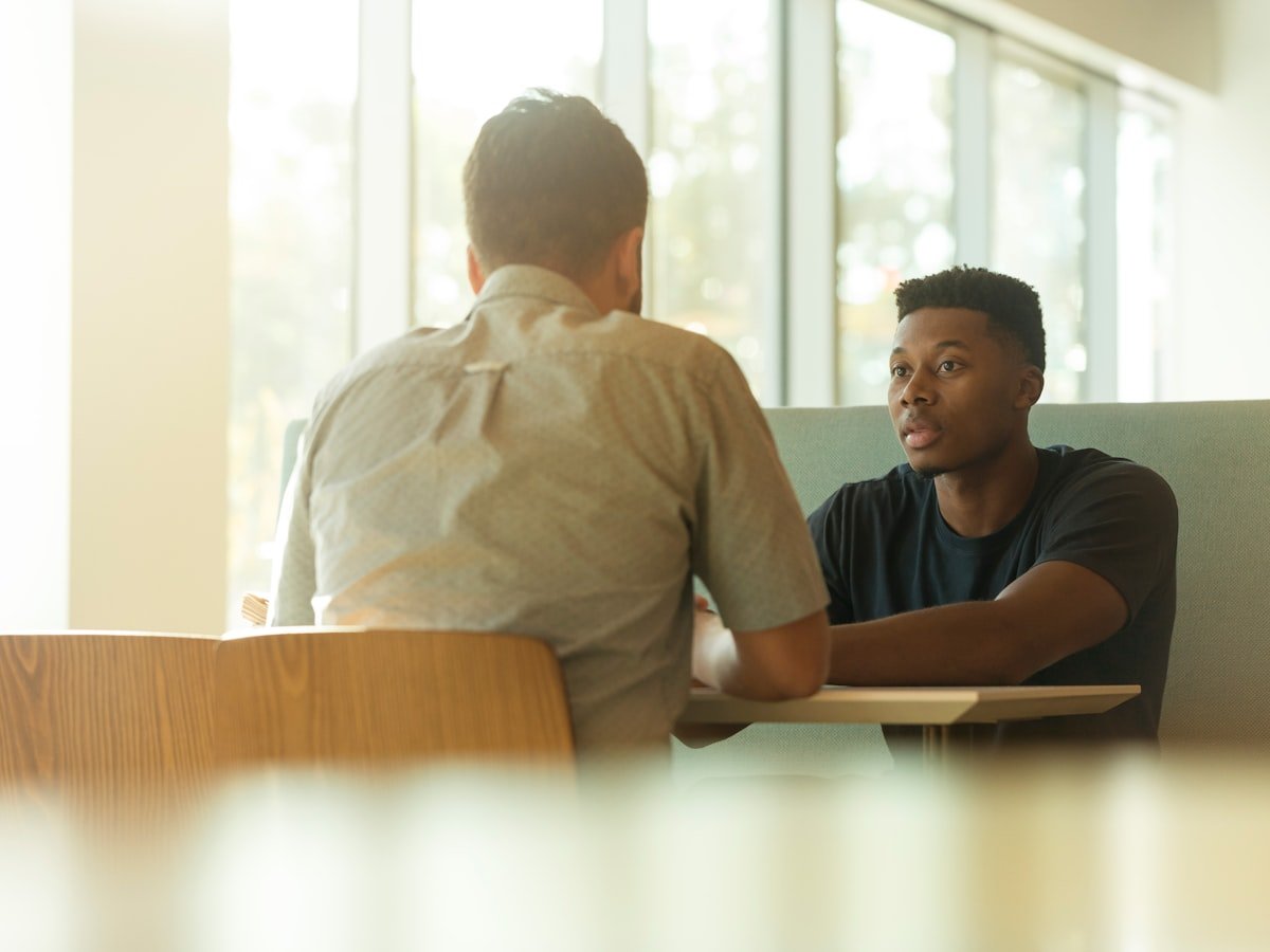 Two men in conversation during a one-to-one coaching session