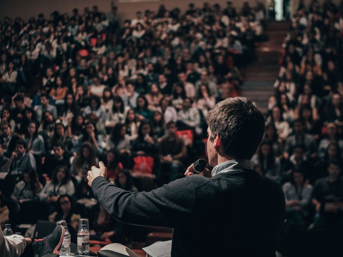 A speaker addressing an audience at a conference